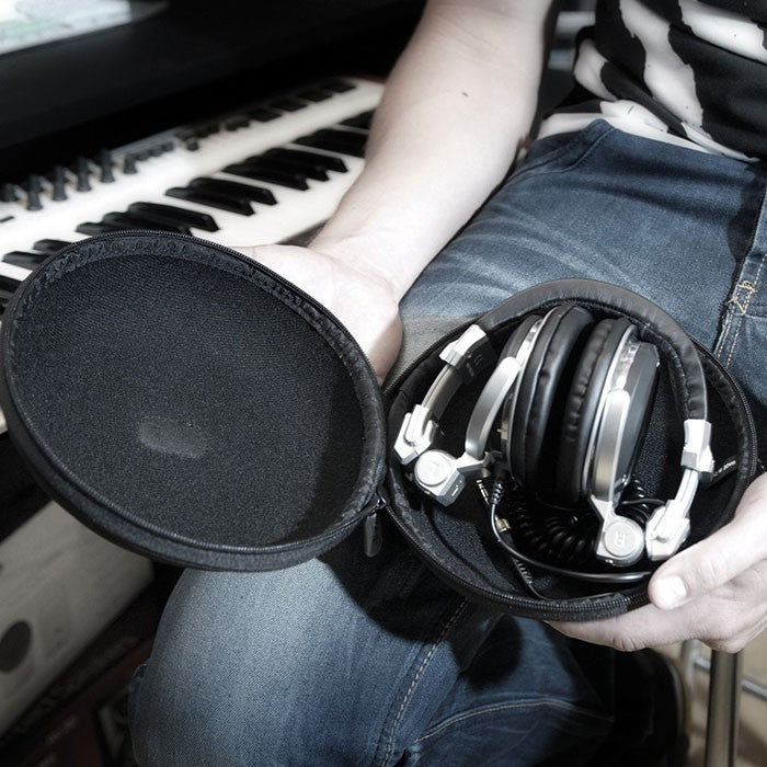 Small UDG Creator headphone case in black with zipper closure, designed to protect and carry headphones.