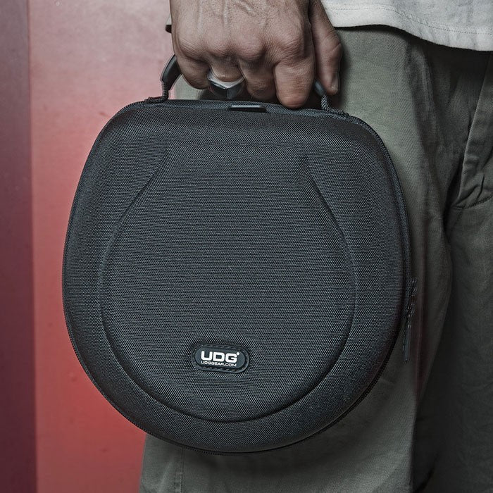 Large UDG Creator headphone hard case in black, designed to protect and store over-ear headphones securely.