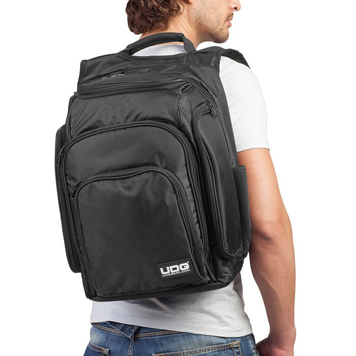 UDG DIGI Backpack in black and orange, designed for DJs with multiple compartments and padded straps for comfort.