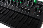Close-up of the Arturia MicroBrute UFO keyboard synthesizer with detailed knobs and controls on a sleek black finish.