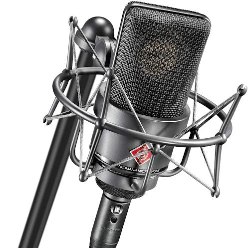Neumann TLM 103 condenser microphone on a stand, with shock mount and cable, ideal for professional studio recording.