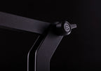 Elgato Wave Desk Stand holding a desktop microphone on a workspace with a computer and accessories.