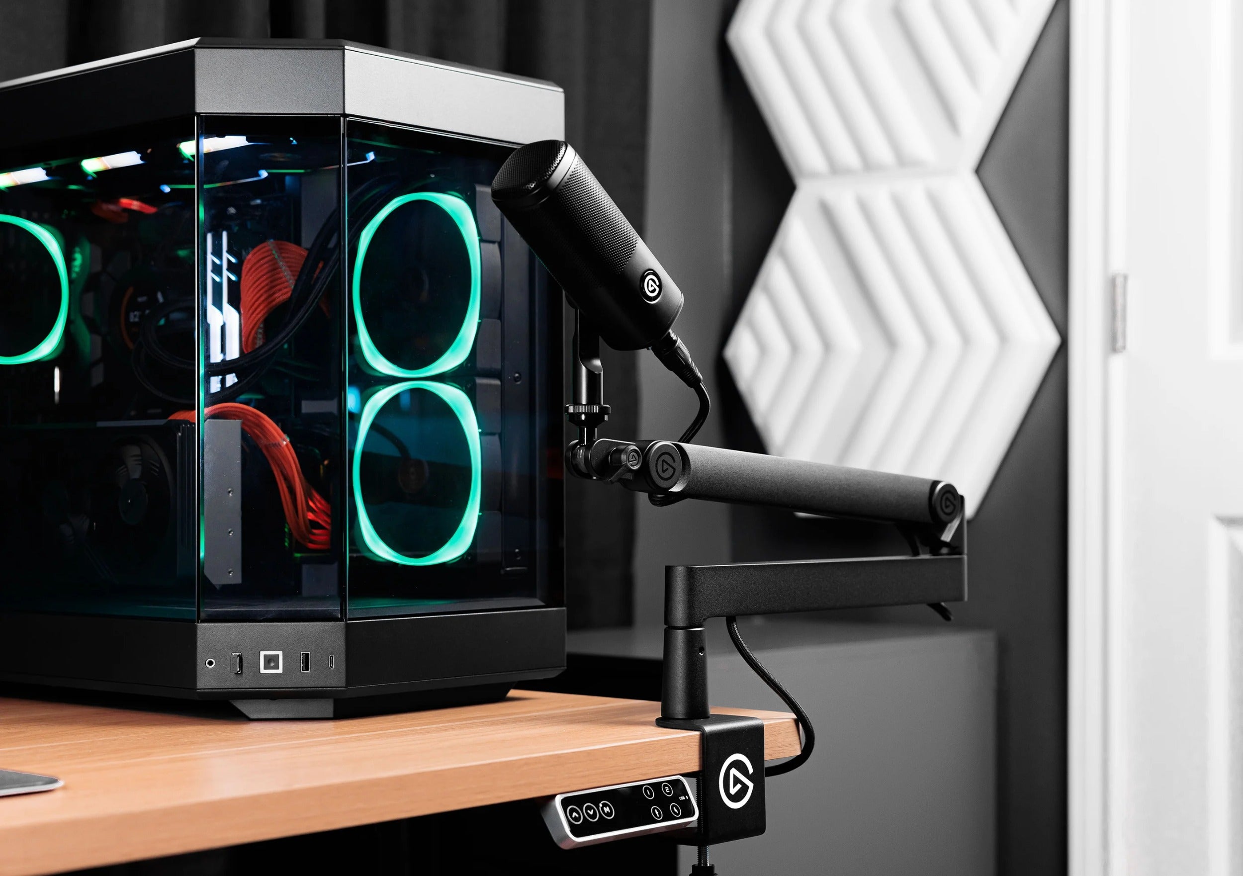 Black Elgato Wave Mic Arm Pro broadcast microphone arm mounted on a desk, showcasing its sleek design and adjustable arm features.
