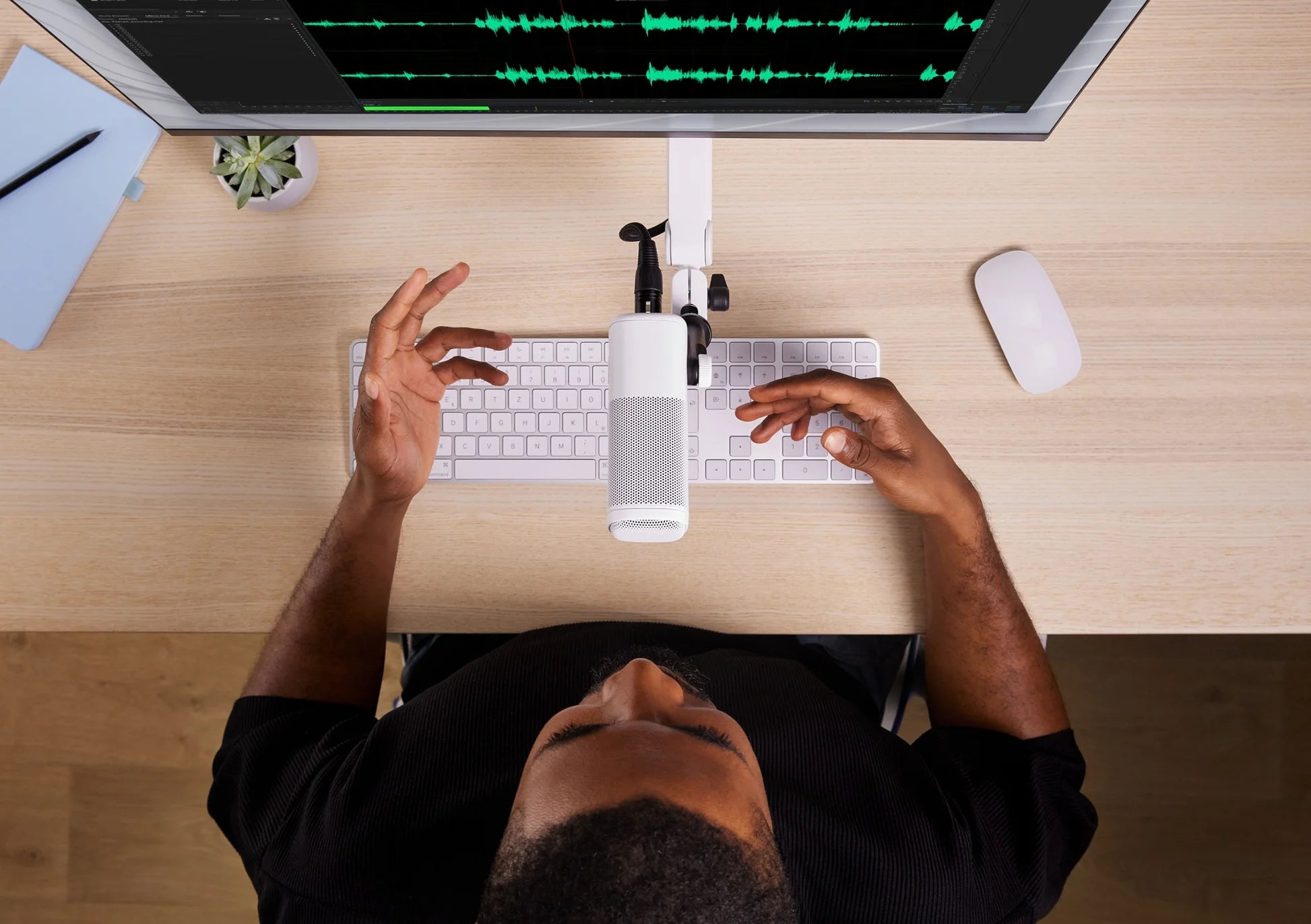 Elgato Wave Mic Arm Pro in white, adjustable broadcast microphone arm with sleek design, shown in a professional workspace setting