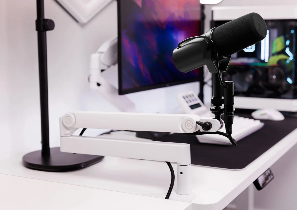 Elgato Wave Mic Arm Pro white broadcast microphone arm mounted on a desk with a microphone attached.