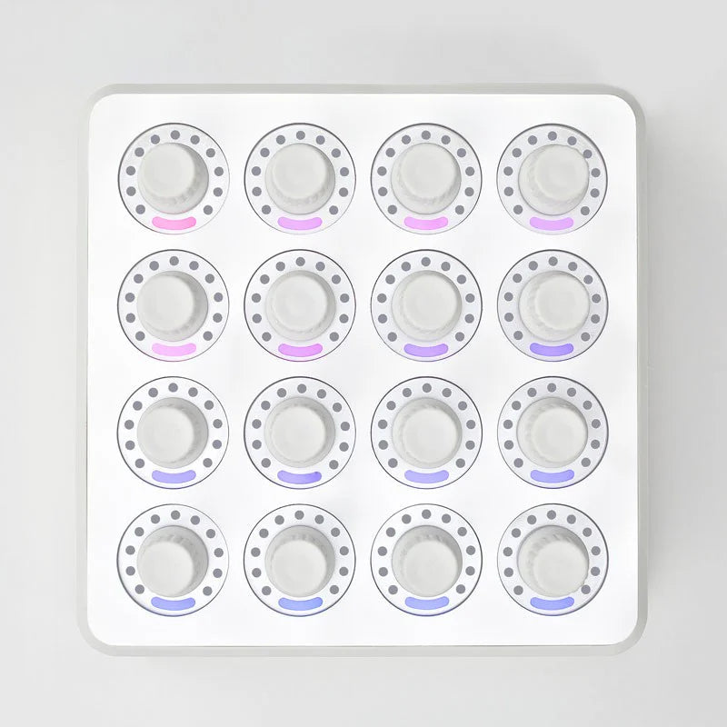 Overhead view of DJ TechTools MIDI Fighter Twister MIDI controller in white with colorful knobs and buttons.