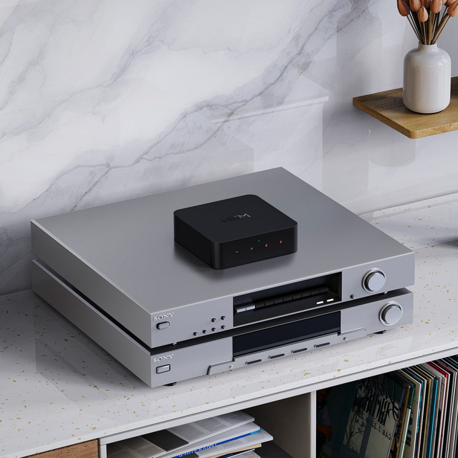 WiiM Pro Plus music streamer device with sleek design and control buttons, used for high-quality audio streaming.