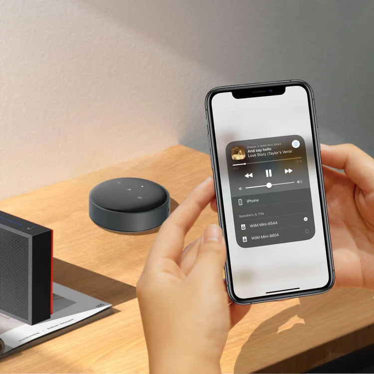 WiiM Mini music streamer device with sleek black design, compact size, and various ports for high-quality audio streaming.