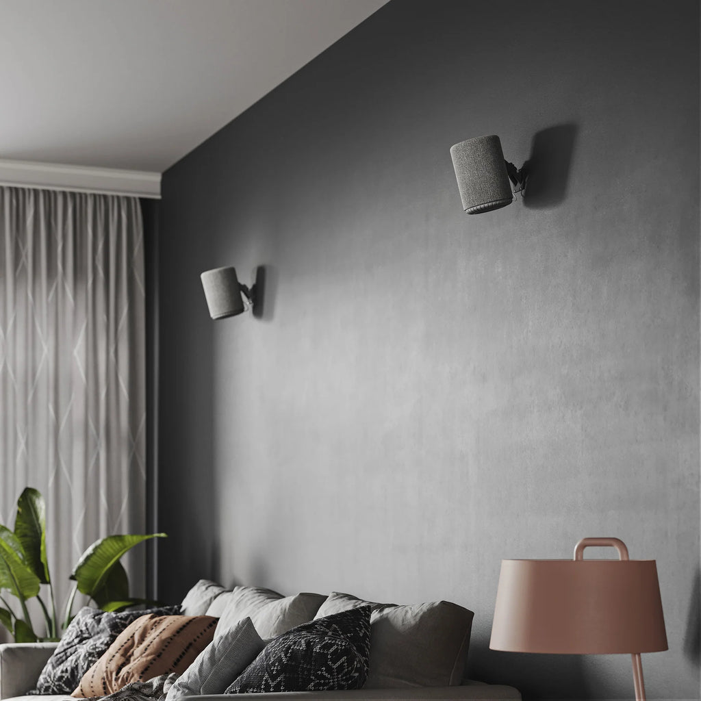 Dark grey Audio Pro A10 MK2 wireless multiroom speaker with AirPlay 2 and Google Cast connectivity, shown in a modern home setting.