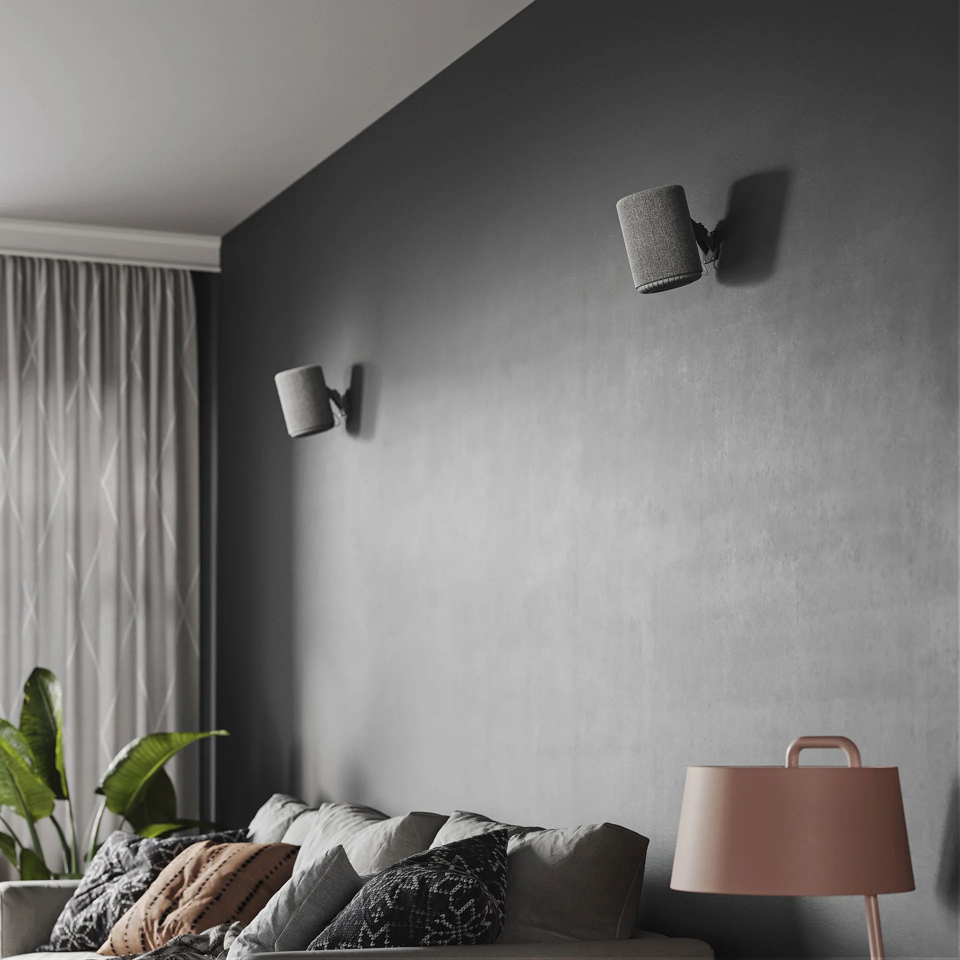 Dark grey Audio Pro A10 MK2 wireless multiroom speaker with AirPlay 2 and Google Cast connectivity, shown in a modern home setting.