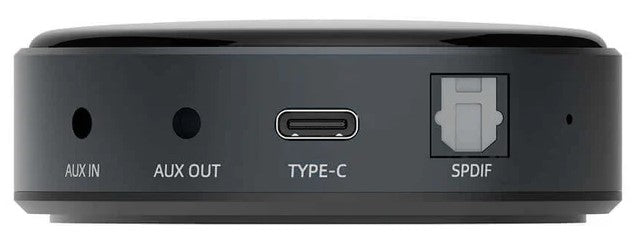 WiiM Mini wireless music streamer connected to a home audio system, compact device for streaming music seamlessly.