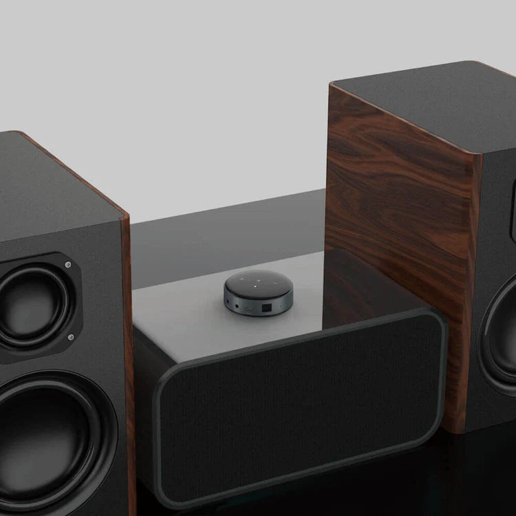 WiiM Mini wireless music streamer device with sleek black design, compact and ready for high-quality audio streaming.