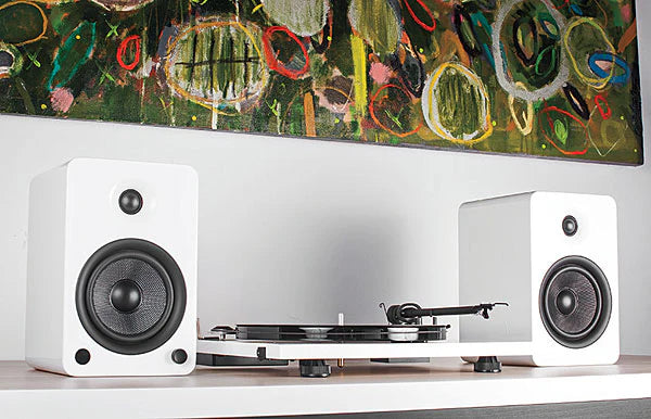 Kanto Audio YU6 wireless speakers with white finish, featuring modern design and audio controls visible on the front.