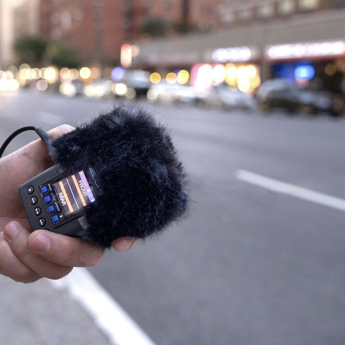 Zoom WSH-2e recorder accessories in use, showing flexible windscreen for outdoor audio recording with Zoom audio equipment.