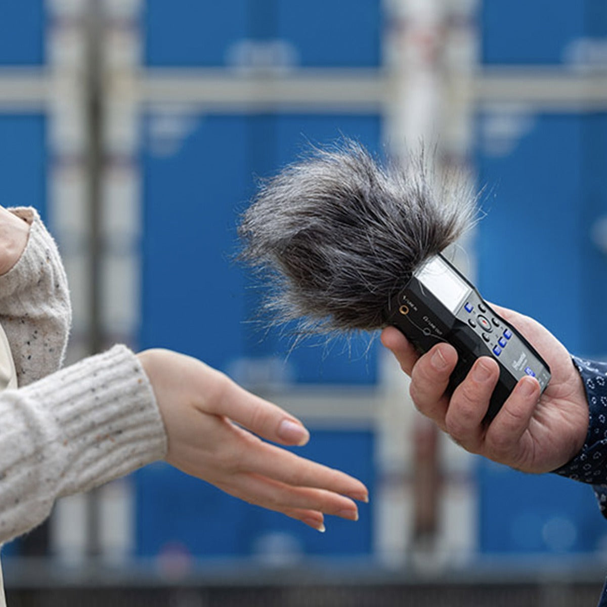 Zoom WSH-4e windscreen for recorder accessories, shown on a Zoom recorder in a lifestyle setting.